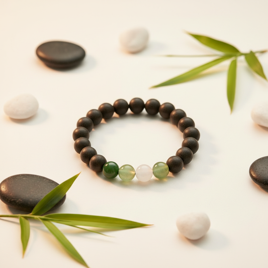Drunken Green Hills dark ebony bracelet warm white background with bamboo leaves and river stones